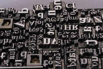 Metal Letterpress Types.
A background from many historic typographical letters in black and white with white background.