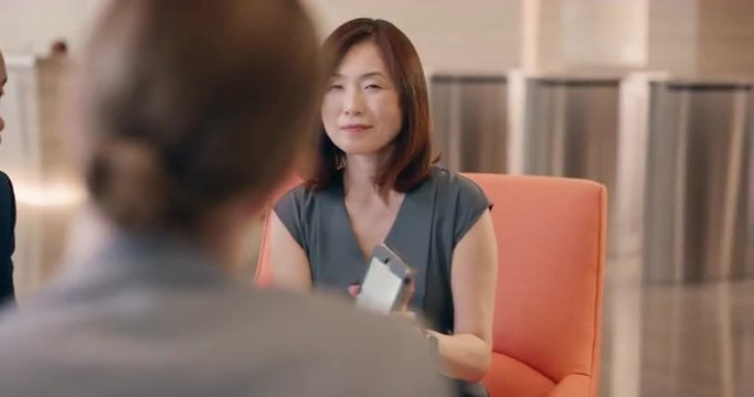 Multi-Ethnic Business people working in business lobby