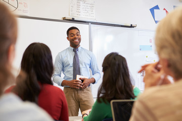 Male teacher in front of students at an adult education class