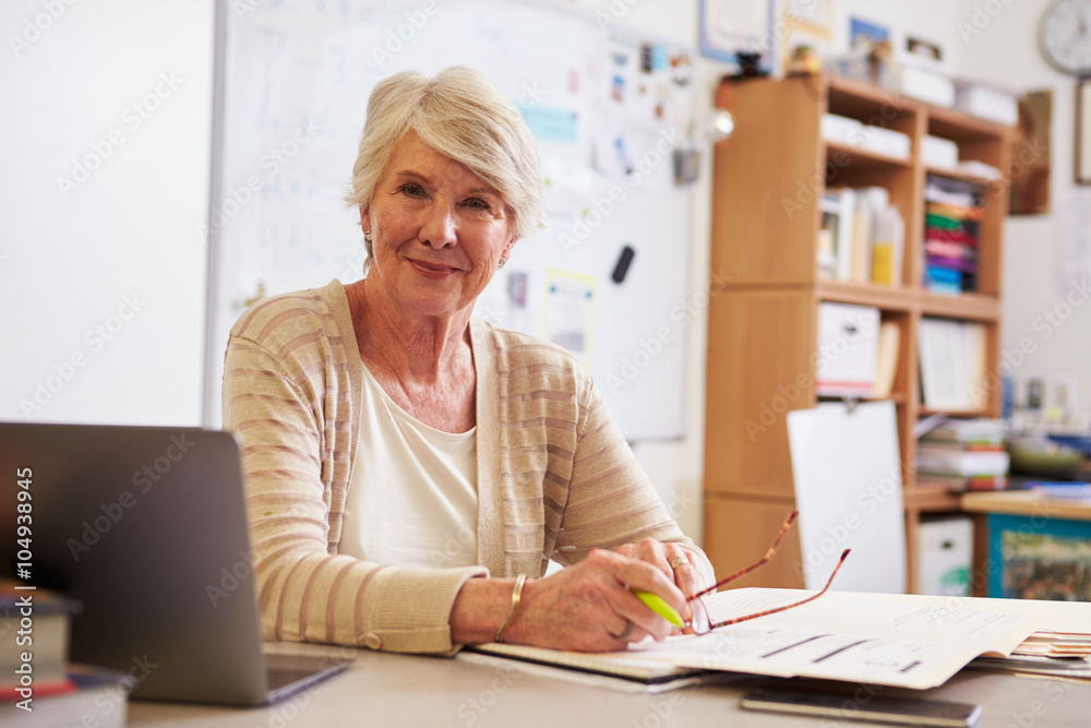 Sticker Portrait of senior female teacher working at her desk