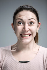 Portrait of young woman with shocked facial expression