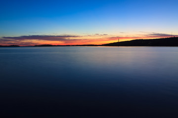 Fototapeta premium Calm sunset and clouds over lake