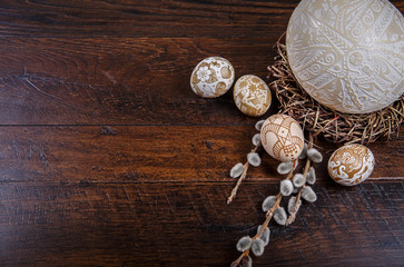  Easter eggs in a nest on a wooden background. Easter Theme. Happy Easter