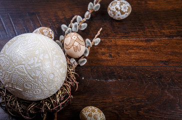  Easter eggs in a nest on a wooden background