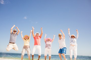 Happy senior friends jumping