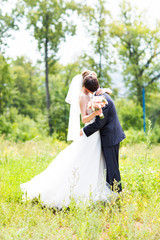 Fototapeta na wymiar Wedding, Beautiful Romantic Bride and Groom Embracing 