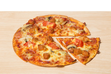 Pizza with sliced vegetables on wood