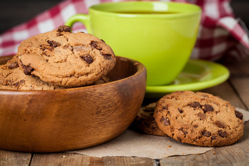 freshly baked chocolate chip cookies on rustic wooden table