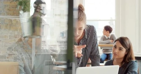 Creative business team meeting in modern start up office female team leader pointing at screen discussing diverse people group teamwork  - Powered by Adobe