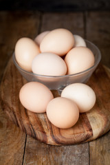 Chicken fresh brown eggs on wooden rustic table