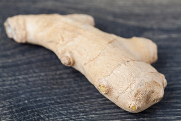Close up of different forms of ginger against a wood worktop. Selective focus.