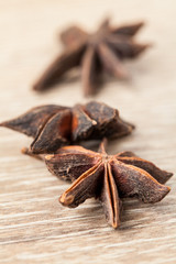 Spices. Anise stars on the vintage wooden surface. Selective focus.