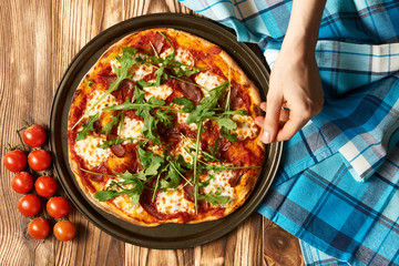Home made pizza on wooden table