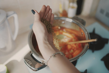 Young woman preparing pumpkin soup