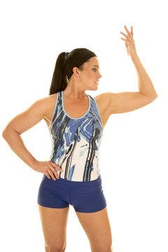 woman in blue fitness outfit hand up