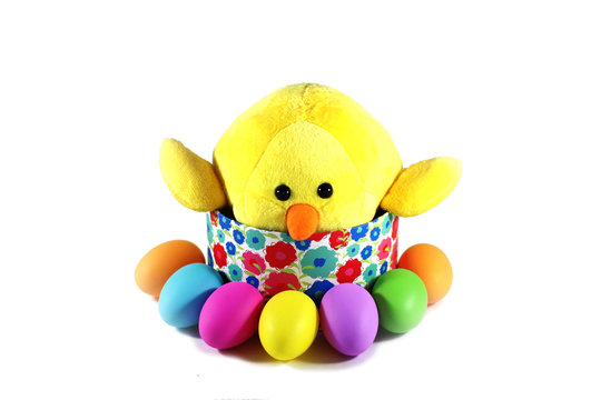 Yellow chick with colorful Easter eggs