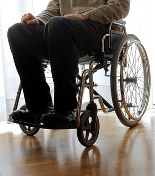 Disabled Elderly In A Wheelchair In The Room