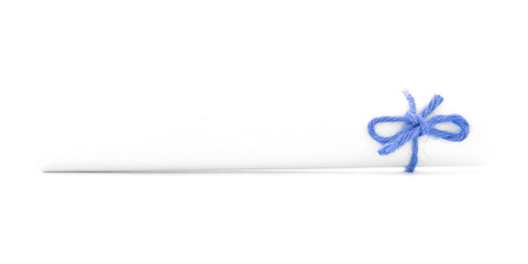 White message tube tied with cord, right blue bow isolated