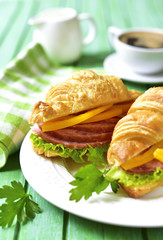 Croissant sandwich with salami and bell pepper.