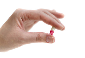 Pink capsule in girl's hand