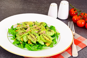 Healthy and diet food: Salad with arugula, avocado, kiwi, cucumb