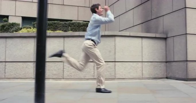 Contemporary funky caucasian businessman street dancer dancing freestyle in the city