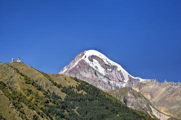 View of Mount Kazbek and Holy Trinity Church (Tsminda Sameba) near Gergeti village, Georgia