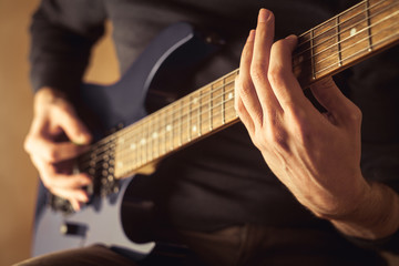 Fototapeta na wymiar Men playing guitar close-up shot
