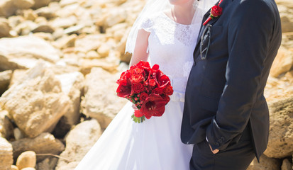 Elegant bride and groom posing together outdoors on a wedding day