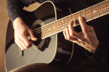 Obraz na płótnie Canvas Men playing guitar close-up shot