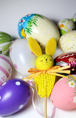 Mix of multicolored vivid Easter eggs and rabbit