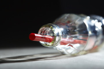 Empty soda bottle and straw
