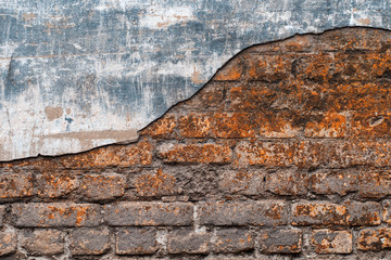 Old brick wall with remains of plaster