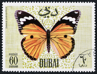 Fototapeta na wymiar DUBAI - CIRCA 1968: A stamp printed by Dubai, shows Butterflyv, Circa 1968