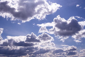 Fototapeta na wymiar Fluffy white clouds and clear blue sky 