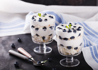 Eton mess - Blueberry with whipped cream and meringue is a Classic British summer dessert in a glass.selective focus