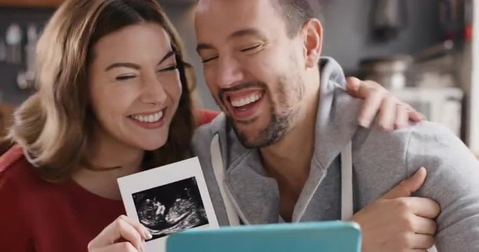 Happy Couple reveals they are pregnant to family over internet using digital tablet
