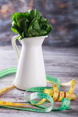 Green spinach in a metal pitcher .Healthy food diet concept. © lily_rocha