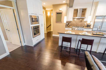 Modern, bright, clean, kitchen interior with stainless steel appliances in a luxury house
