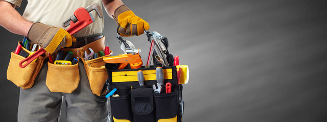 Builder handyman with construction tools. - 104960339