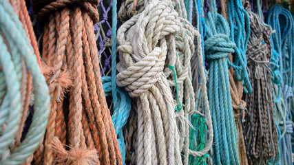 Nautical background. Closeup of old colorful mooring ropes , Old