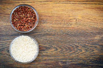 Obraz na płótnie Canvas White and Red Rice in Glass Cup on Wooden Background