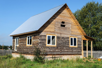 Unfinished wooden house from a bar