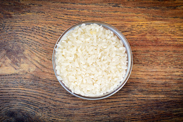 White Rice on Wooden Background
