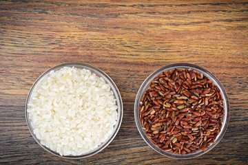 White and Red Rice in Glass Cup on Wooden Background