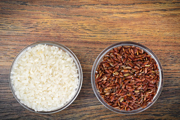 White and Red Rice in Glass Cup on Wooden Background