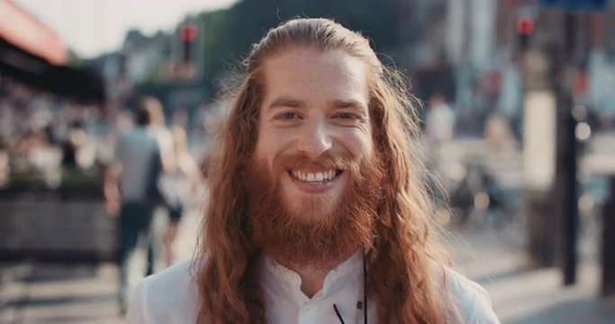Slow motion portrait of happy hipster man with beard smiling