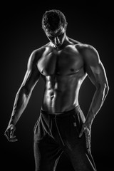 Fototapeta na wymiar Sporty healthy man posing and showing his perfect boddy