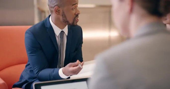 Multi-Ethnic Business people working in business lobby