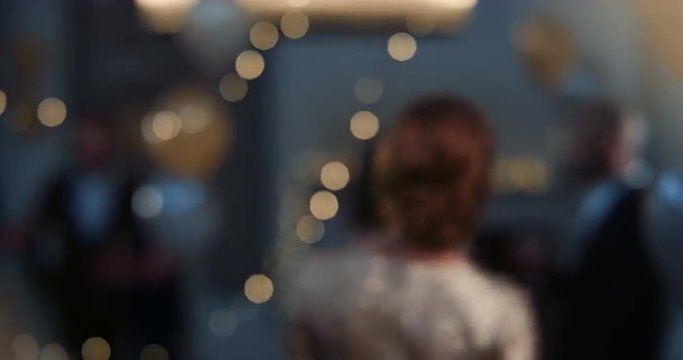 Elegant woman dressed in gold holding cocktail